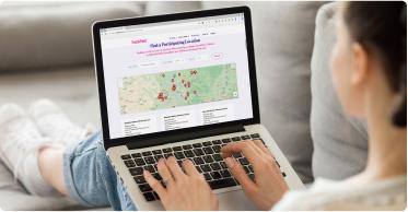 Person using laptop showing map with marked locations and "Safe-to-Walk" route options.