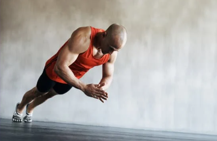 Man performing push-up exercise on a flat surface.