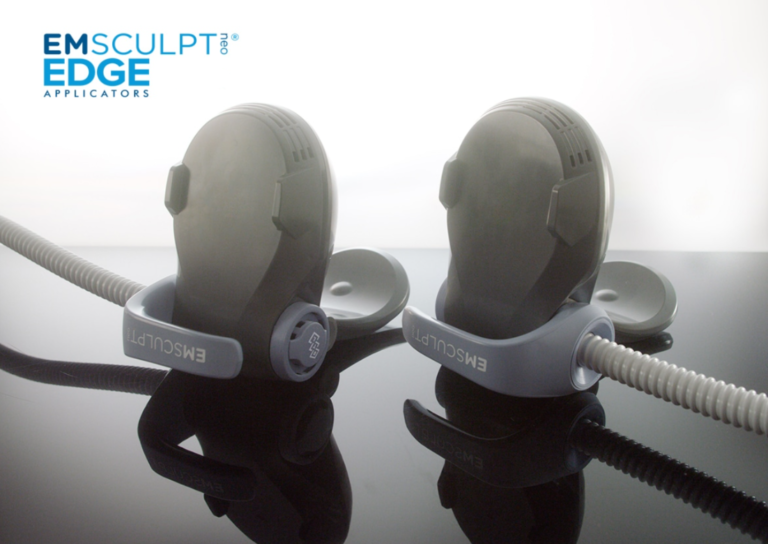 Two EMSculpt NEO Edge applicators connected by cables for muscle stimulation treatment.