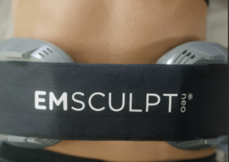 EMSculpt Neo device worn around the abdomen with electrodes visible on sides.