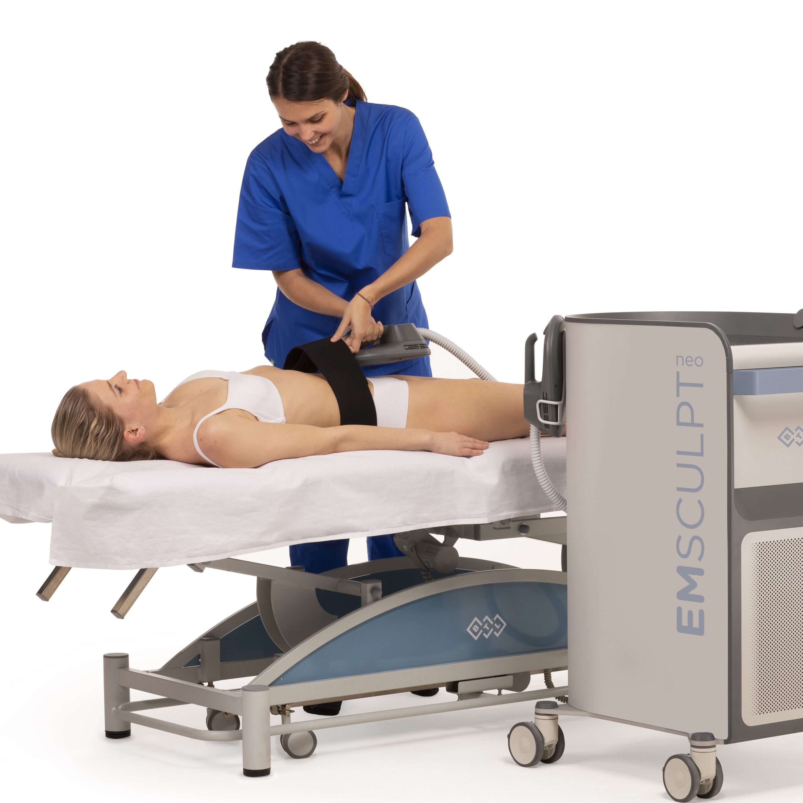 A healthcare professional operating EMSculpt Neo device on a patient lying down for body contouring treatment.